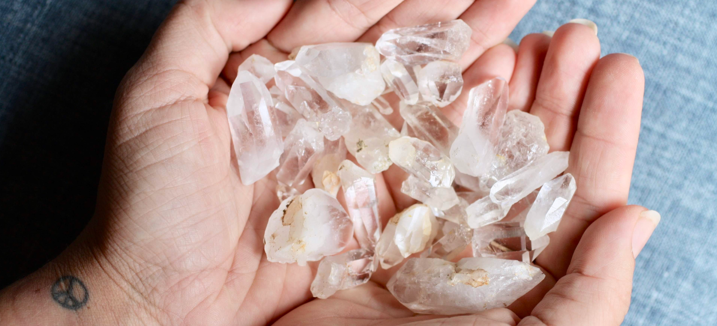Hands holding healing crystals symbolizing gemstone essences and spiritual wellness featured in the Star Essence newsletter