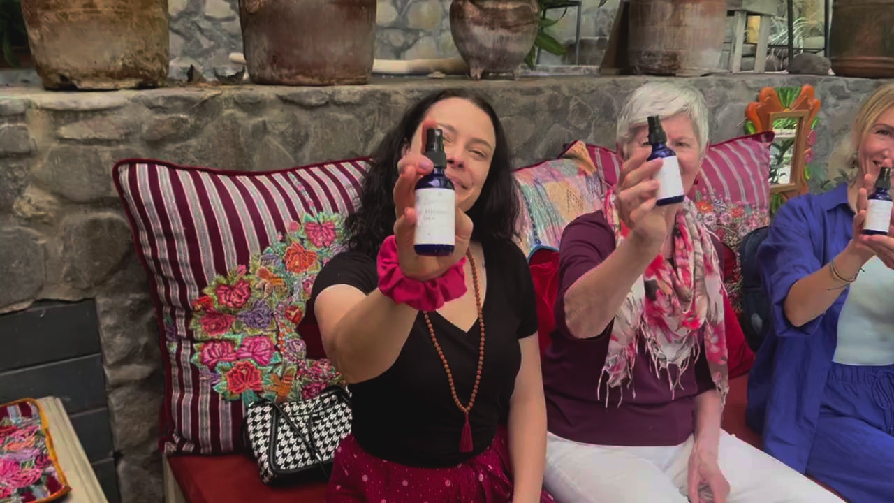 Three women smiling and holding Holy Harmony Spray by Star Essence, symbolizing vibrational medicine, emotional harmony, and holistic healing support