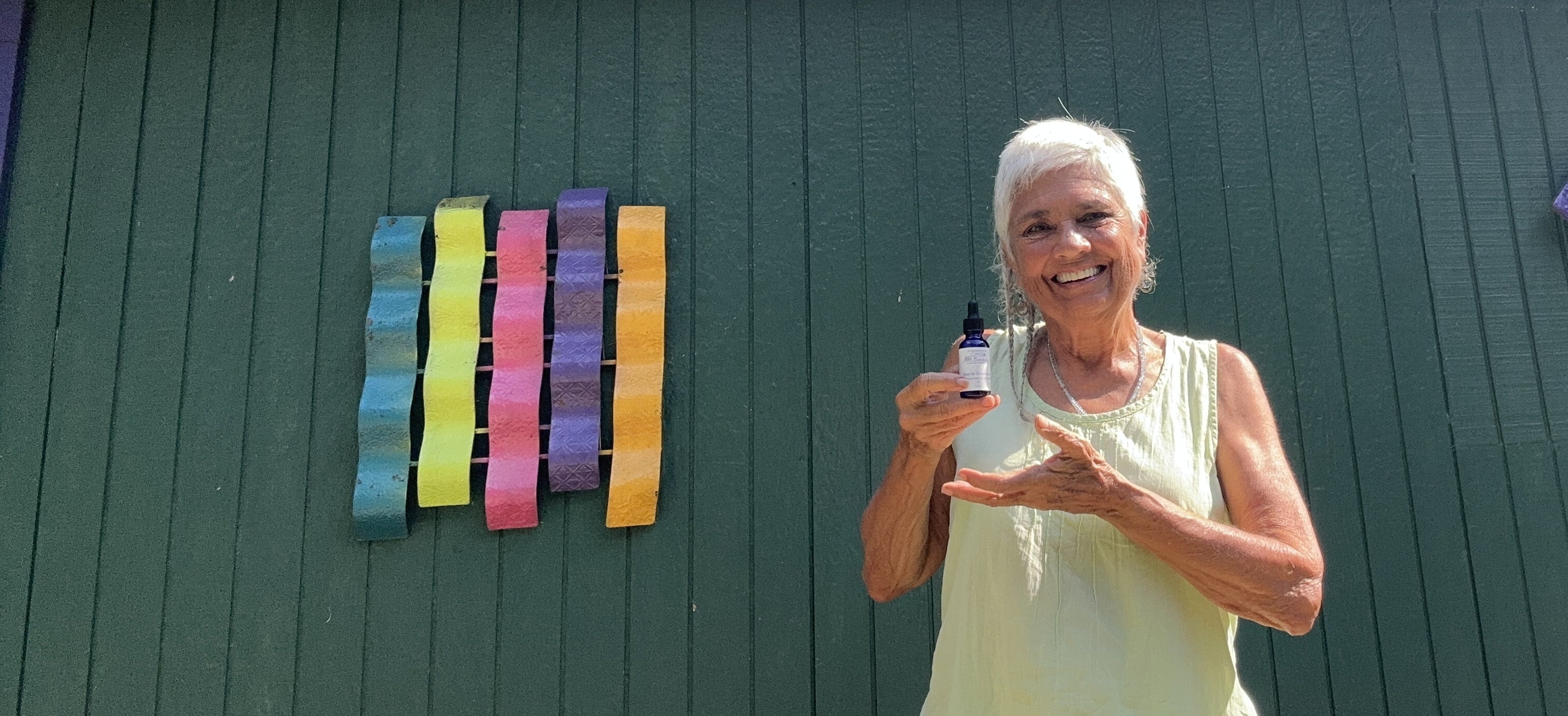 Star, founder of Star Essence, holding Exalted Endocrine — a handcrafted energy healing essence for holistic medicine and spiritual wellness