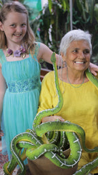 Star and a young girl holding friendly emerald tree boas during the creation of the serpent essence, highlighting compassion, trust, and holistic medicine traditions.
