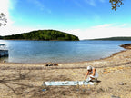 Star sitting on the sandy shore of Lake Ouachita during the eclipse essence ceremony, capturing the energy used to create the TOTALITY Arkansas Quartz gem essence.