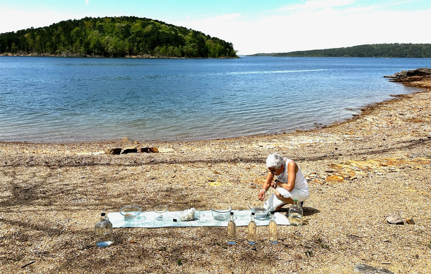 Star standing by the lakeside holding Totality essence, supporting cosmic perspective, energy healing, and spiritual wellness