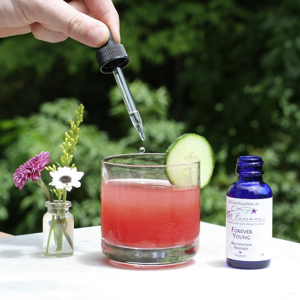 Forever Young essence being dropped into a drink for holistic medicine and energy healing rejuvenation