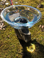 Shungite stone in a bowl of water used for gemstone essence supporting energy healing and spiritual wellness